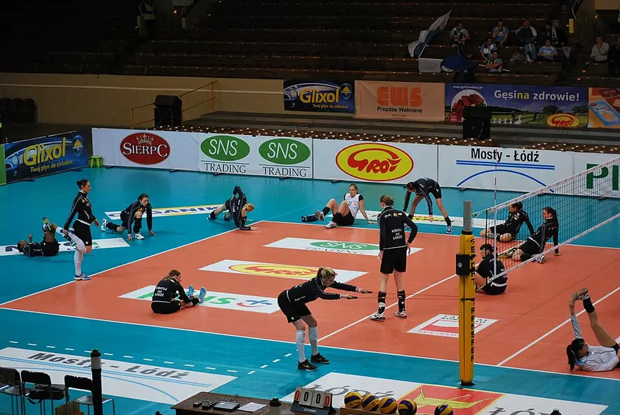 Team warm-up on an indoor volleyball court